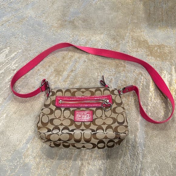 COACH Crossbody bag with heart shaped zipper monogram with pink trim and strap